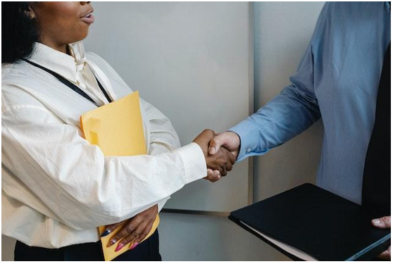 Co-workers shaking hands after a meeting